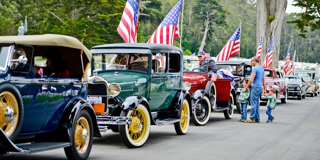 Memorial Day parade with cars and flags