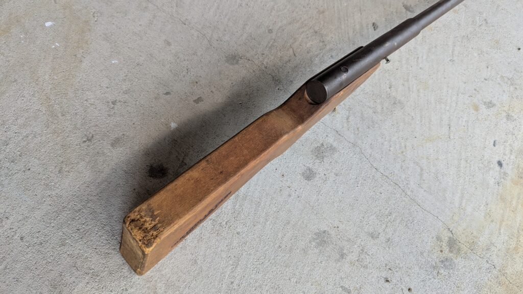 Vintage guerrilla firearm with wood stock and steel tubing