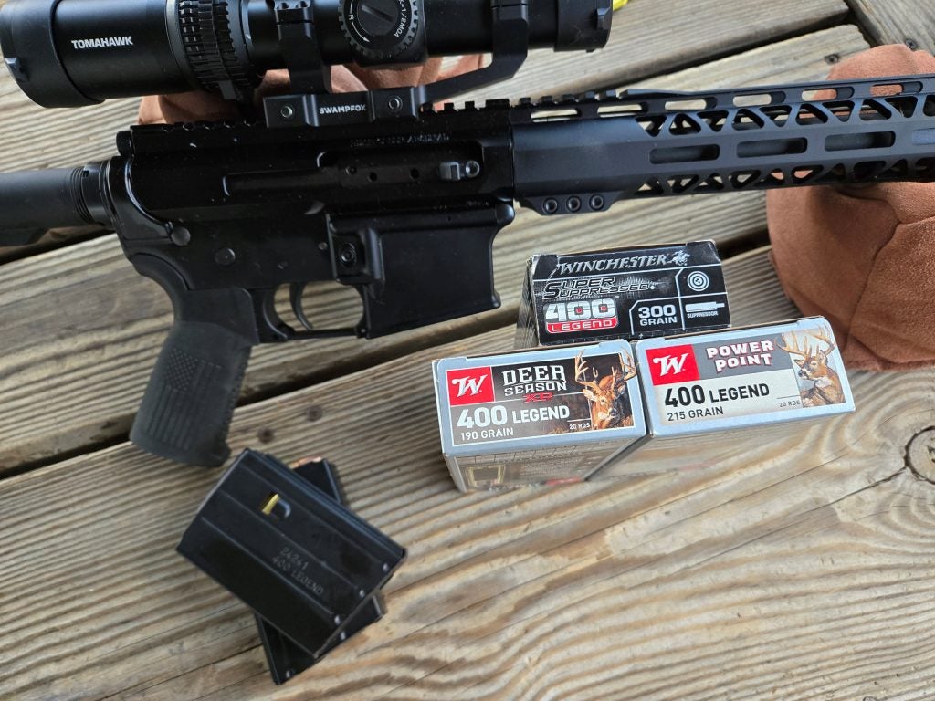 .400 Legend ammunition next to BC-15 AR rifle at the range